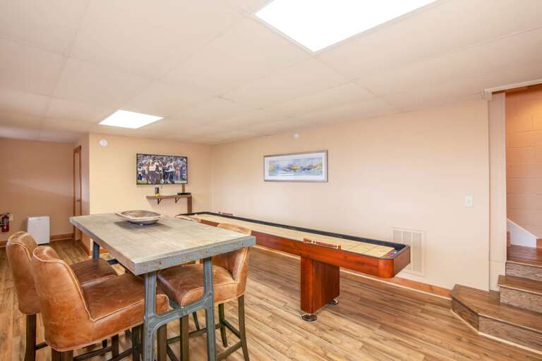 Game Room on Lower Level with Shuffleboard Table and HD Smart TV Game Room on Lower Level with Shuffleboard Table and HD Smart TV