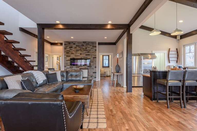 Living Area with Contemporary Leather Furniture, High Ceilings with Exposed Beams Living Area with Contemporary Leather Furniture, High Ceilings with Exposed Beams