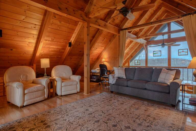 Loft Offers an Addition Living Space or Sleeping Area with a TV, Desk, and Multiple Seating Options