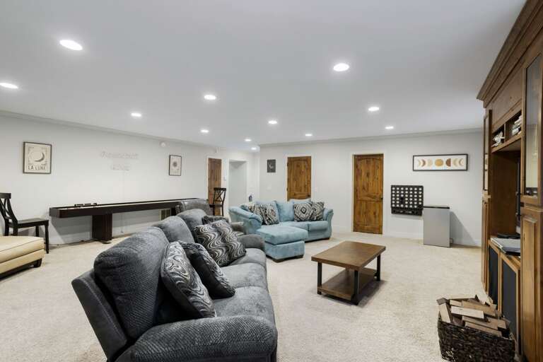Downstairs Den and Game Room with HDTV and 12-foot Shuffleboard Table