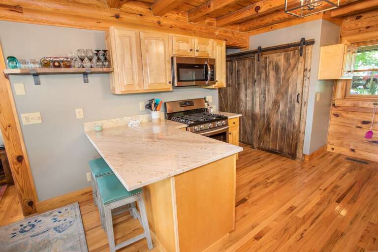Kitchen Boasts Stainless Appliances and Granite Counters, Custom Barnwood Sliding Door hides Washer and Dryer Kitchen Boasts Stainless Appliances and Granite Counters, Custom Barnwood Sliding Door hides Washer and Dryer