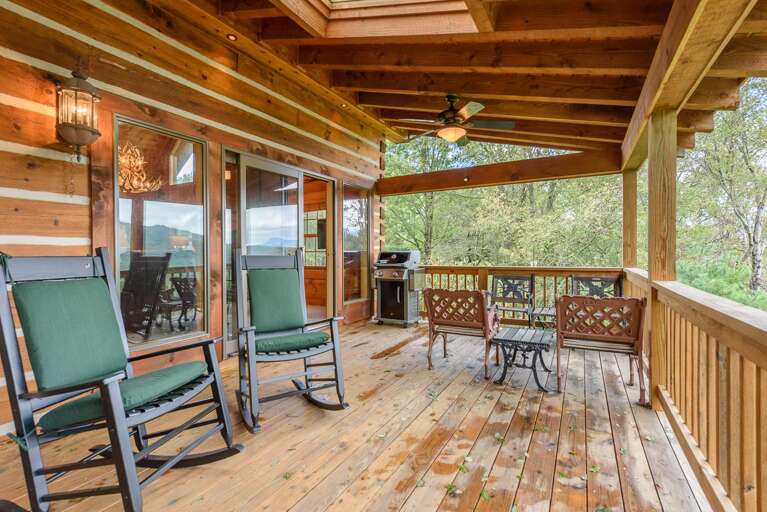 Large Rear Covered Deck features Rocking Chairs and Four Conversational Chairs with Side Tables Large Rear Covered Deck features Rocking Chairs and Four Conversational Chairs with Side Tables