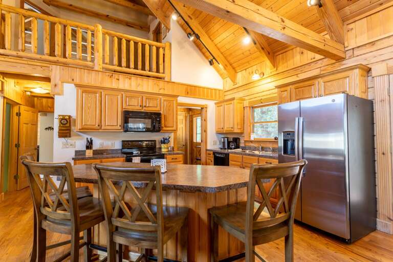 Open Kitchen with Island Bar Seating and Dining Room