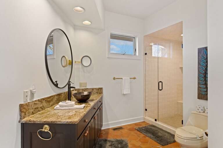 'His' Bathroom in the Master Suite includes a Tiled Walk-in Shower and Large Vanity