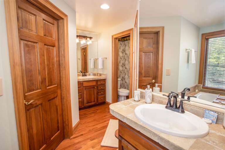 Two Seperate Vanities and a Water Closet