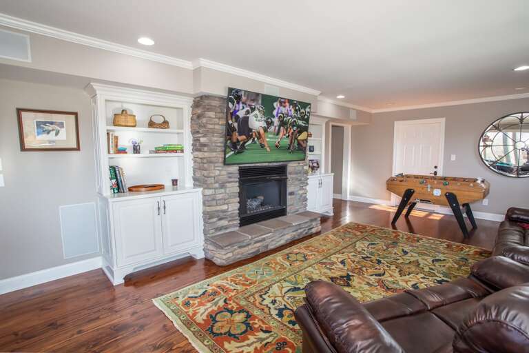 Living Area on Third Floor with Stone Fireplace and Flat Screen TV