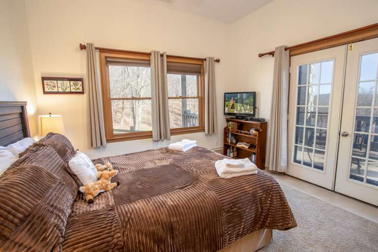 Lower Level Queen Bedroom with HD Smart TV, Huge Windows, and Glass Door onto Rear Deck Lower Level Queen Bedroom with HD Smart TV, Huge Windows, and Glass Door onto Rear Deck