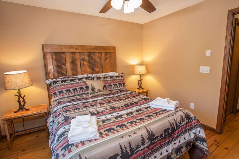 Main Level Queen Bedroom with Barnwood Headboard, Rustic Lamps and Bedside Tables Main Level Queen Bedroom with Barnwood Headboard, Rustic Lamps and Bedside Tables