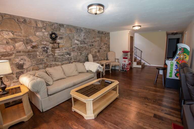 Lower Level Den Adjacent to Theater Area, with Comfy Sofa, Arcade Game, and Popcorn Machine Lower Level Den Adjacent to Theater Area, with Comfy Sofa, Arcade Game, and Popcorn Machine