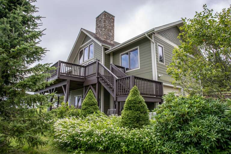 Exterior Stairs go from Patio down to Courtyard with Outdoor Dining Table and Hot Tub