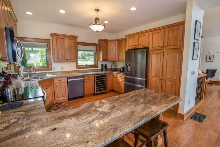 Gorgeous Granite Countertops with Undermount Sink and Bar Stool Seating at Island Peninsula