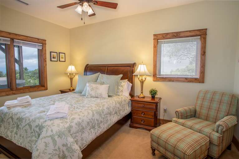 Lower Level Queen Bedroom with Comfy Chair and Ottoman