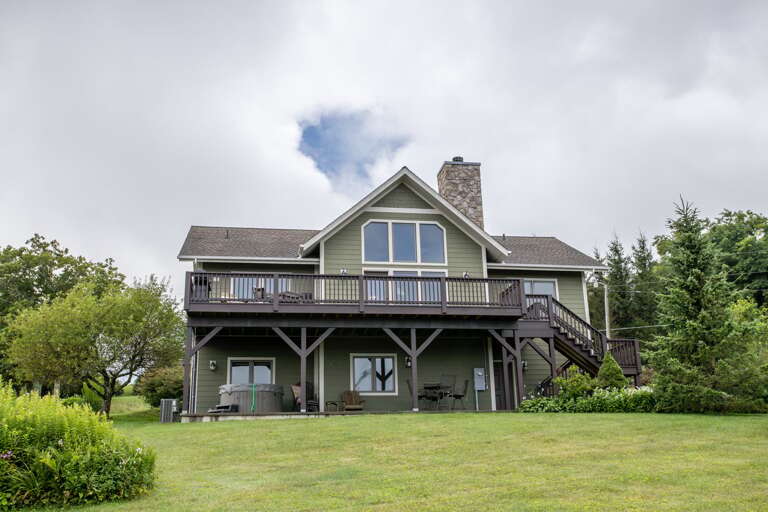 Rear Exterior of Bald Eagle Bluff, with Main Level Patio and Lower Level Courtyard