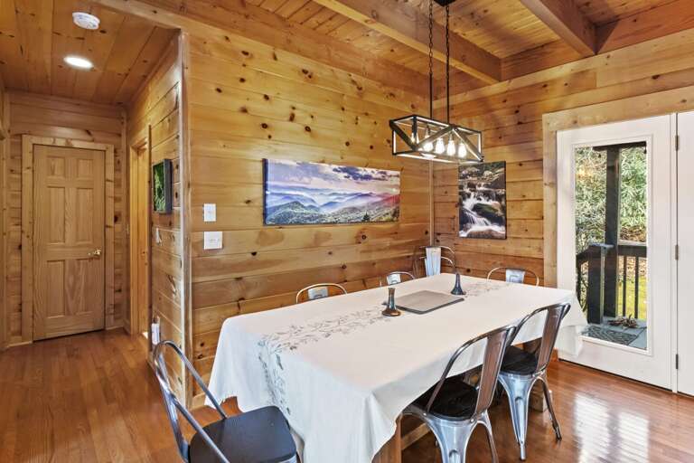 Banquet-style Dining Table seats 8 guests, with 3 more barstool seats at adjacent Kitchen Bar Top.
