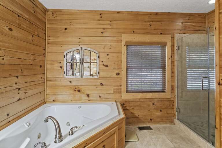 Master Bathroom has a Jetted Soaking Tub, and Separate Shower with Tile and Frameless Glass