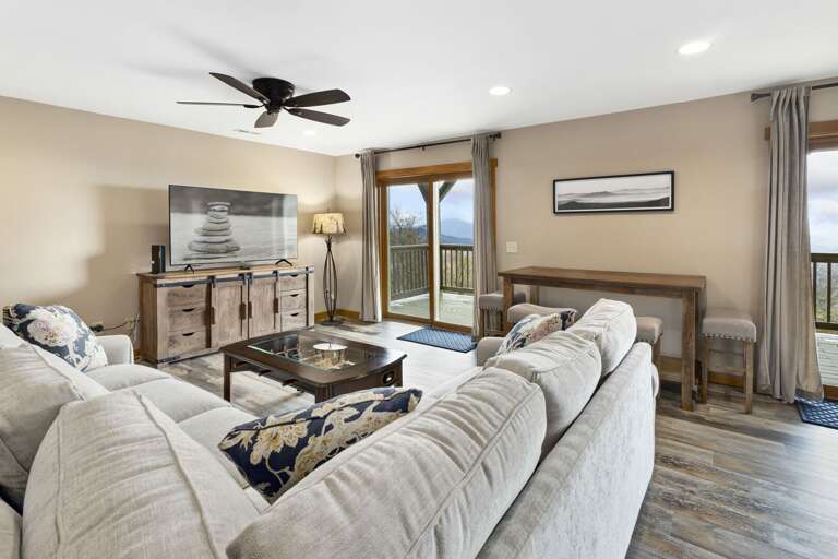 Lower Level Living Room with Large TV and Bar Area