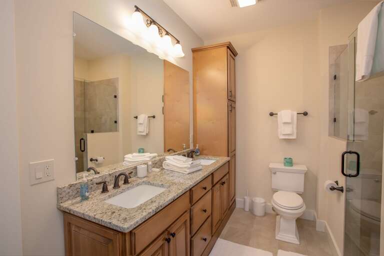 Lower Level Full Bathroom with Double Vanity and Walk-In Shower