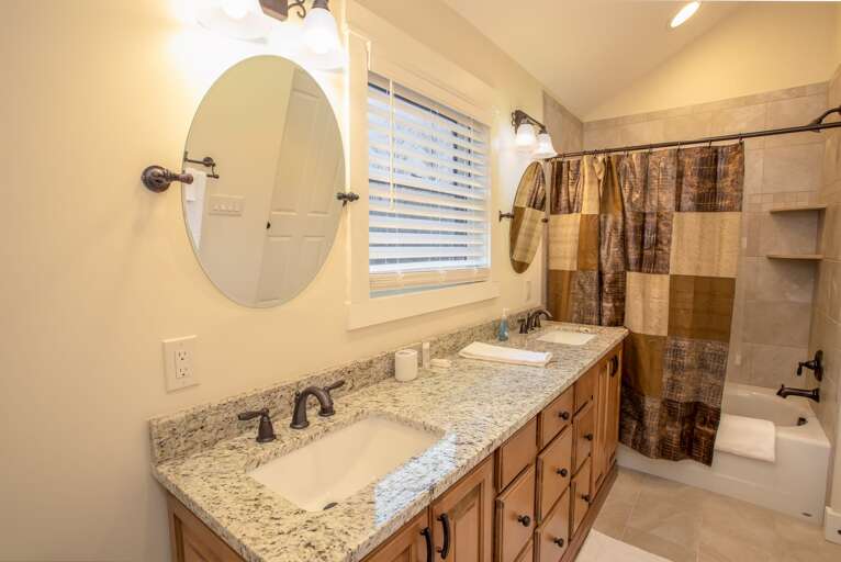Private Upper Level King Bathroom with Large Double Vanity and Tiled Tub/Shower Combo