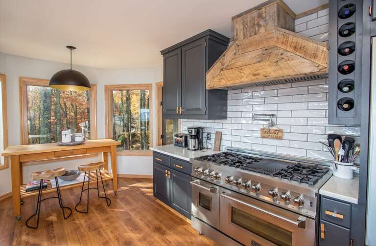 Custom Kitchen with Gas Cooktop and Counter Height Breakfast Bar which seats Two