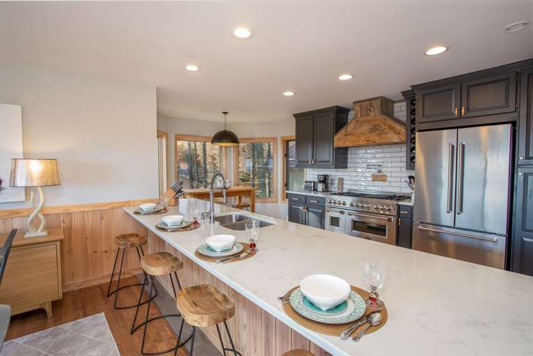 Huge Quartz Island with Barstool Seating for Four - adjacent to Dining Table