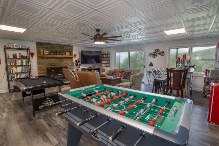 Den with game tables and bar