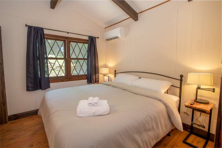 Cozy King Bed with Flanking Bedside Tables and Lamps.