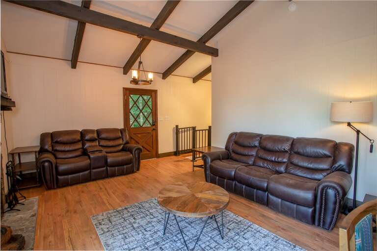 Great Room on Main Level with Comfy Leather Furniture, Vaulted Ceilings and Exposed Beams
