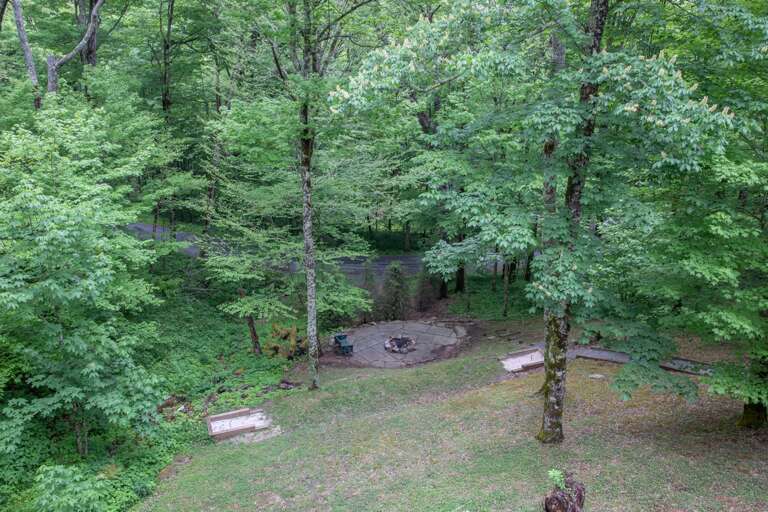 Firepit below the home in the yard Firepit below the home in the yard
