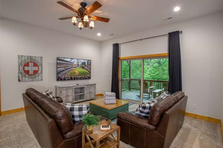 Lower level seating area with TV and game room area Lower level seating area with TV and game room area