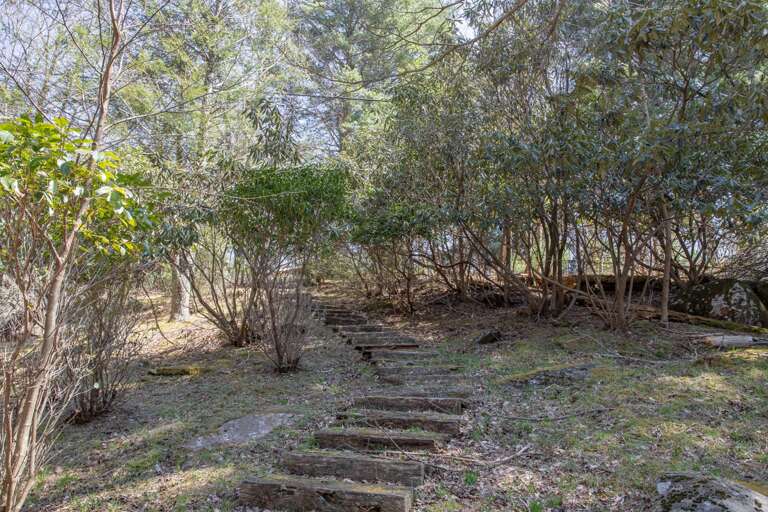 Railroad Tie Steps lead up the hill  and through the woods on the Happy Apple grounds
