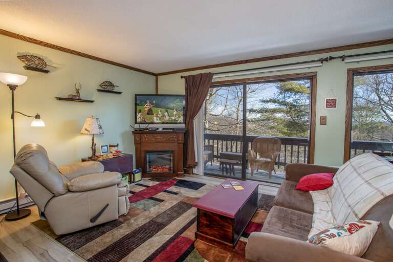 Sofa and Recliner in Living Area of Holiday Hideaway, Huge Wall of Glass look out at Mountains!