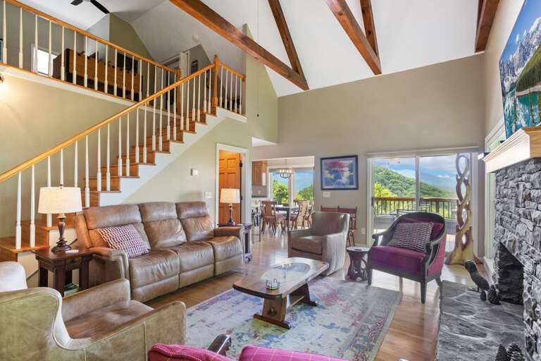 Great Room with Wood Floors, Vaulted Ceilings, and Exposed Beams with Loft Above Great Room with Wood Floors, Vaulted Ceilings, and Exposed Beams with Loft Above