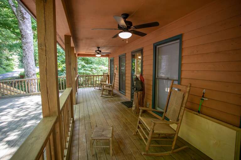 Large Covered Front Porch with Cornhole, Rocking Chairs, and Level Front-Door Entry Large Covered Front Porch with Cornhole, Rocking Chairs, and Level Front-Door Entry