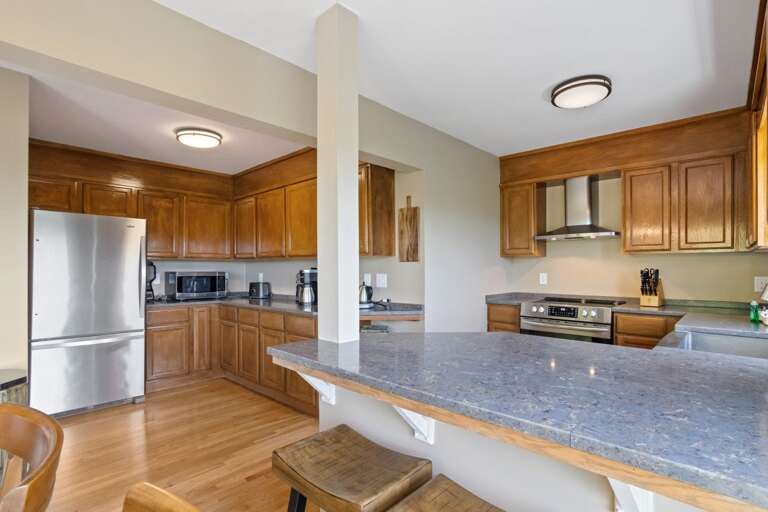 Updated Kitchen with Wood Floors, Granite Counters, and Stainless Appliances Updated Kitchen with Wood Floors, Granite Counters, and Stainless Appliances