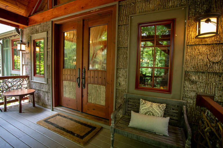 Main Entrance on Covered Front Porch boasts Custom Double Front Doors!