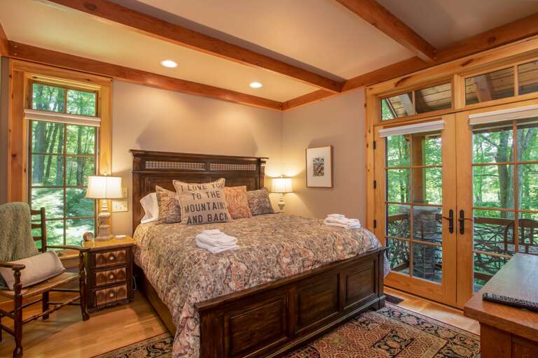 Main Level Master Bedroom Suite with King Bed, HD Smart TV, Walk-in Closet, and Private Porch