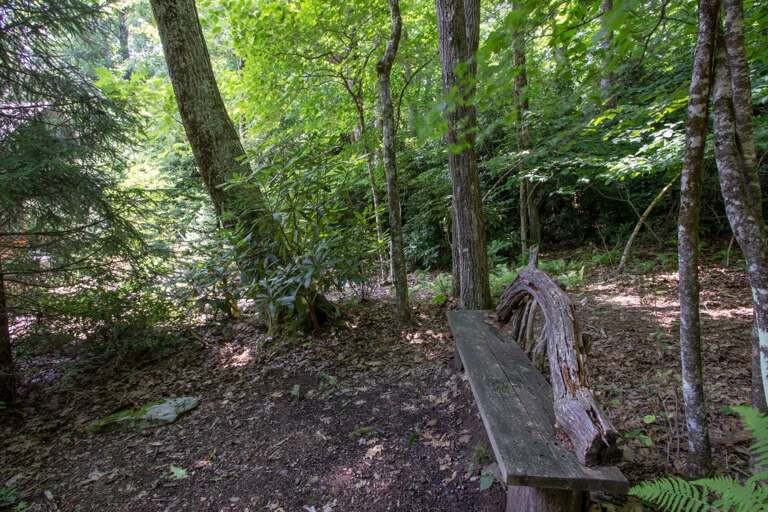 Rustic Bench-style seating along the walking trails on-property