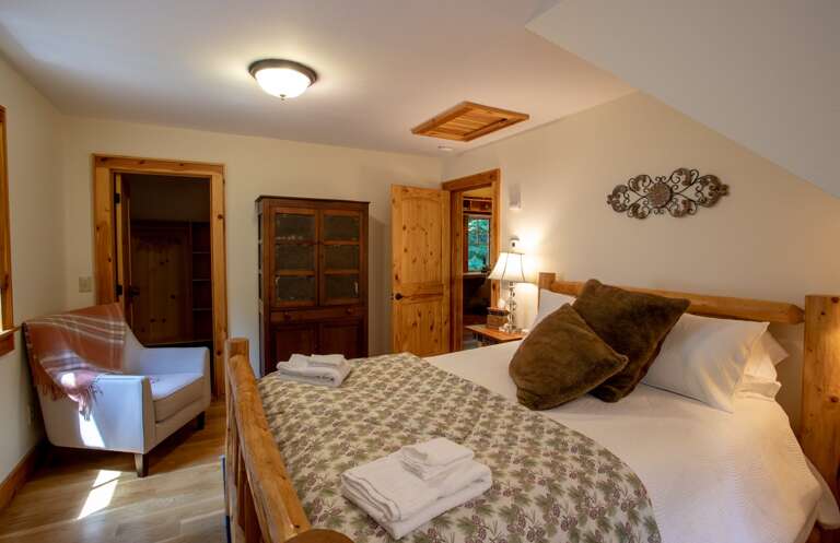 Upper Level Queen Bedroom with comfy Armchair and Huge Closet