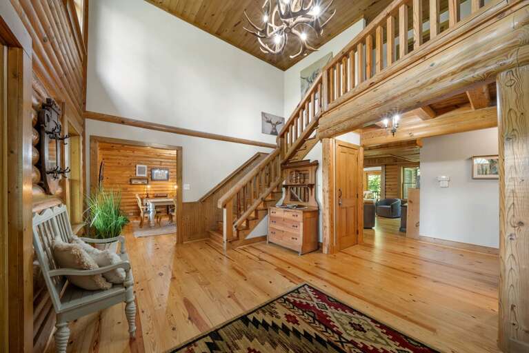 Vaulted Ceilings in the Foyer with a Beautiful Wood Staircase