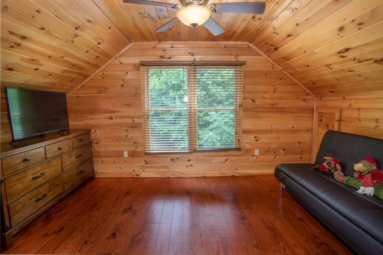 TV, Dresser and Ceiling Fan in Upstairs Room with Single and Futon TV, Dresser and Ceiling Fan in Upstairs Room with Single and Futon