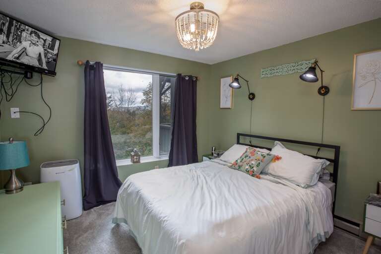 Queen Bedroom with Huge Windows which look out at Mountain Views