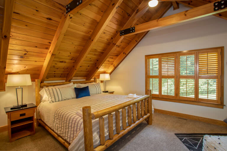 Huge Upstairs Bedroom with Custom King Log Bed, Vaulted Ceilings with Exposed Beams and Tongue-and-Groove