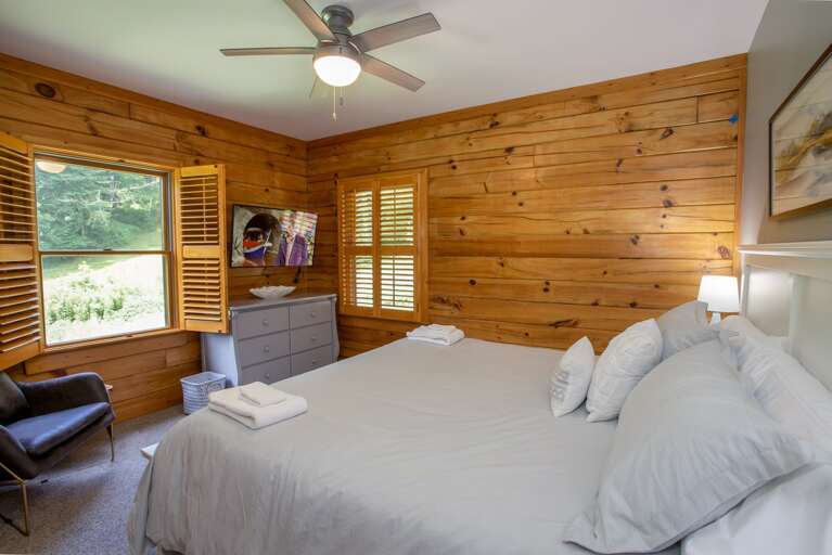 Main Level King Bedroom with HD Smart TV and Comfortable Armchair