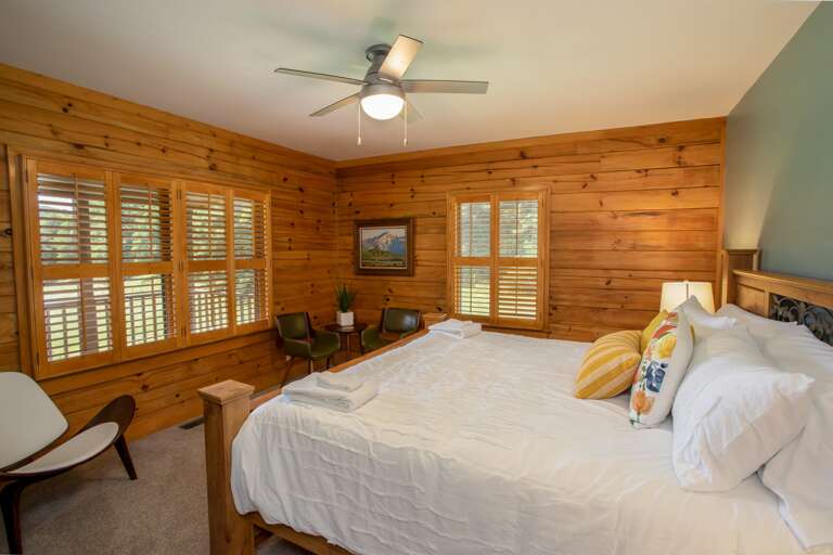 Master Suite on Main Level with King Bed, Pine Tongue-and-Groove Walls, and Large Windows which frame Mountain and Valley Views!