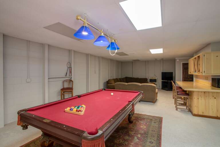 TV and couches also in gameroom with bartop seating