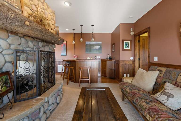 Double Sided Stacked Stone Gas Fireplace with Sofa