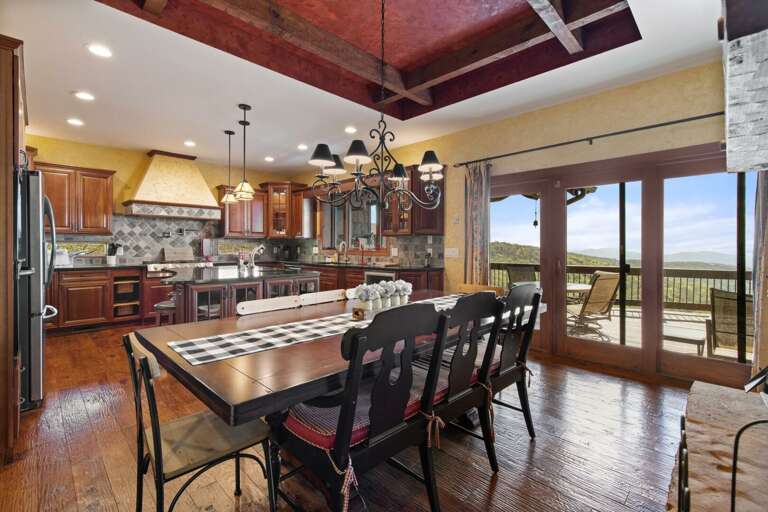 Indoor Dining Area has Large Sliding Glass Doors Adjacent to Kitchen