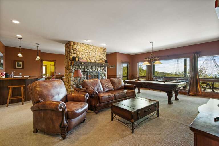 Lower Level Den with Wet Bar, Pool Table, Fireplace and Covered Deck