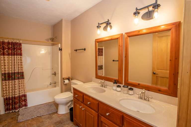 Lower Level Full Bathroom with Double Vanity and Tub/Shower Combo