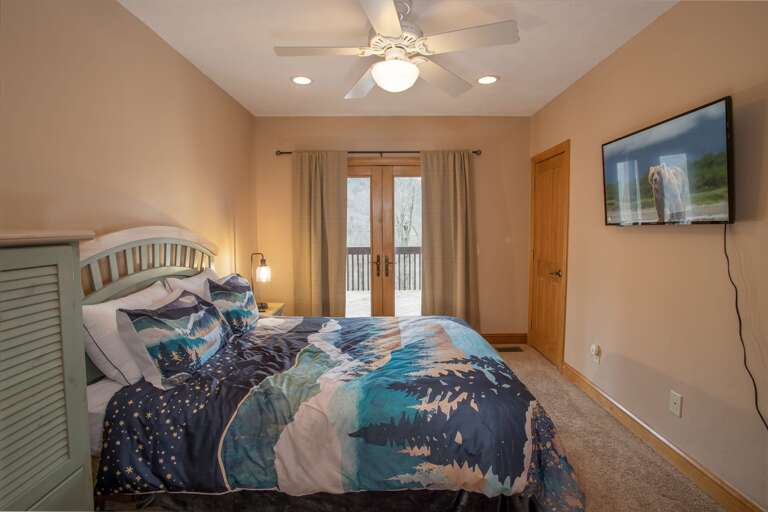 Lower Level Queen Bedroom with HD Smart TV and Glass Doors to Deck and View